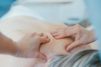A woman receiving chiropractic treatment.